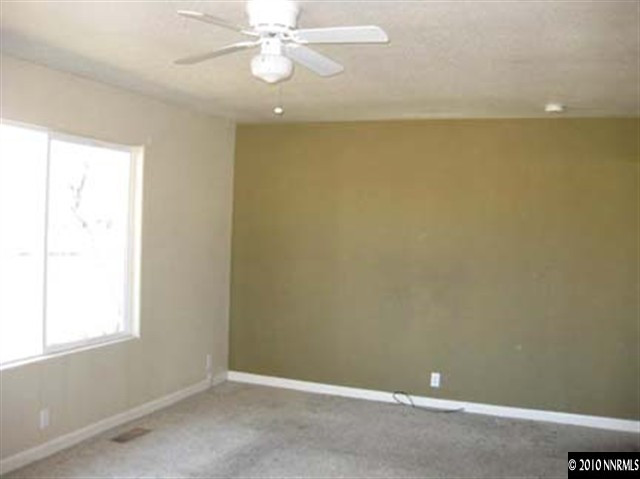 1580 Trainer Way Reno, NV 89512 - Photo 4 of 9 an empty room with a fan & a window