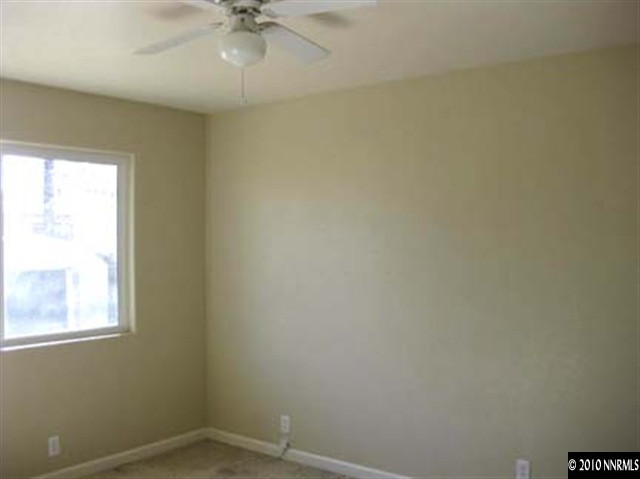 1580 Trainer Way Reno, NV 89512 - Photo 6 of 9 an empty room with a window and a fan