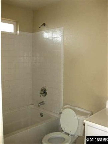 1580 Trainer Way Reno, NV 89512 - Photo 7 of 9 a bathroom with a granite countertop toilet a sink and bathtub
