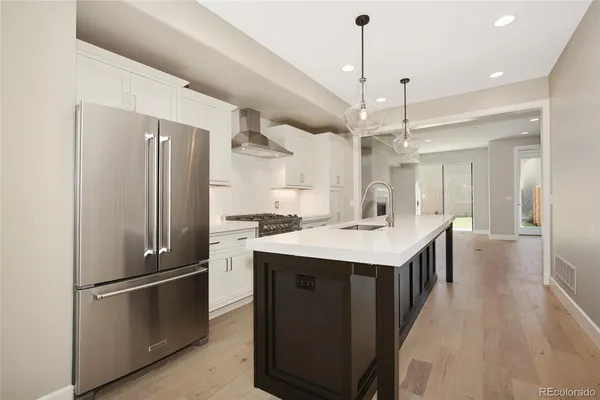 a kitchen with kitchen island a sink stainless steel appliances and cabinets