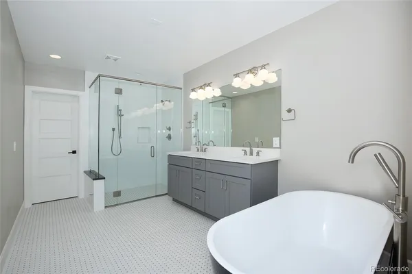 a bathroom with a double vanity sink mirror and shower