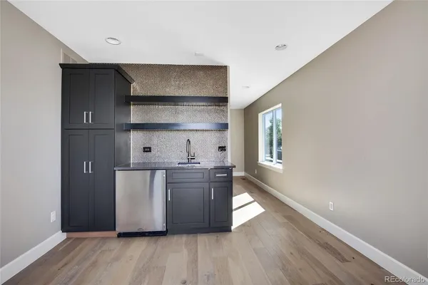 a kitchen with stainless steel appliances a wooden floors and sink