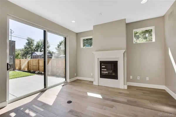 a view of a livingroom with a fireplace and window