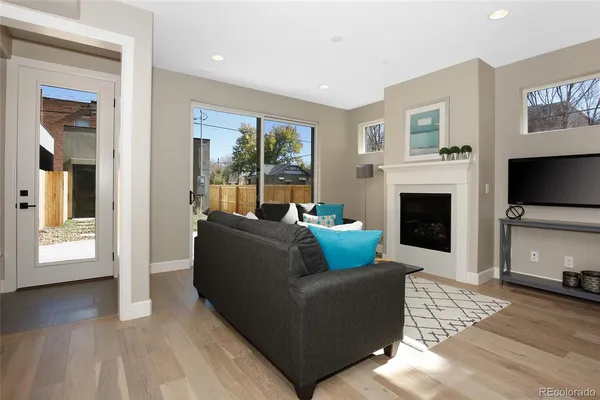 a living room with furniture flat screen tv and a fireplace