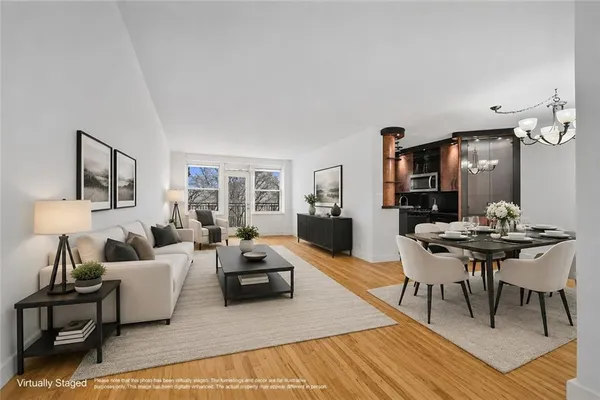 a living room with furniture a wooden floor and a table