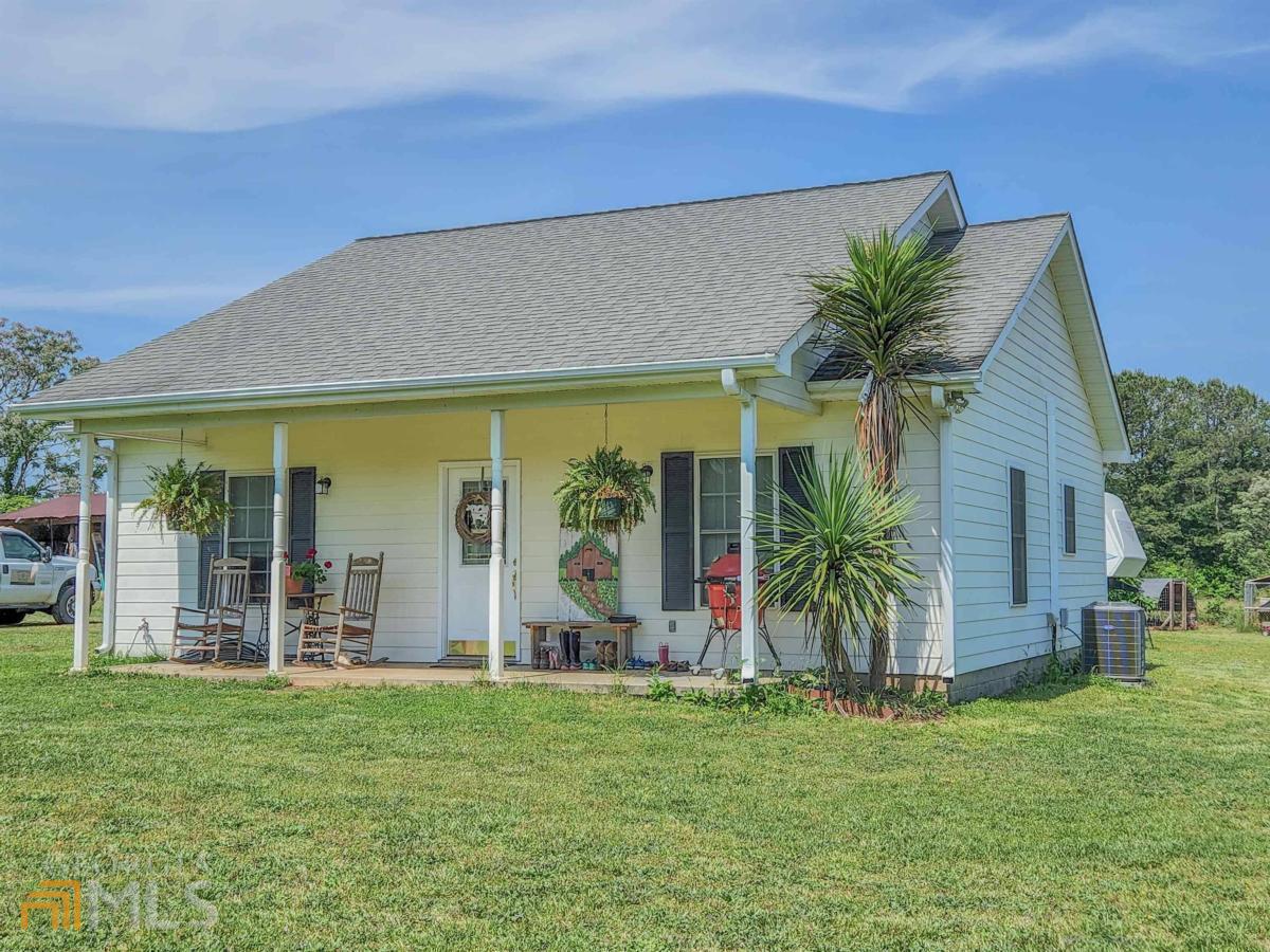 1451 Keencheefoonee Road Rutledge, GA 30663 - Photo 1 of 1 front view of house with a yard and potted plants