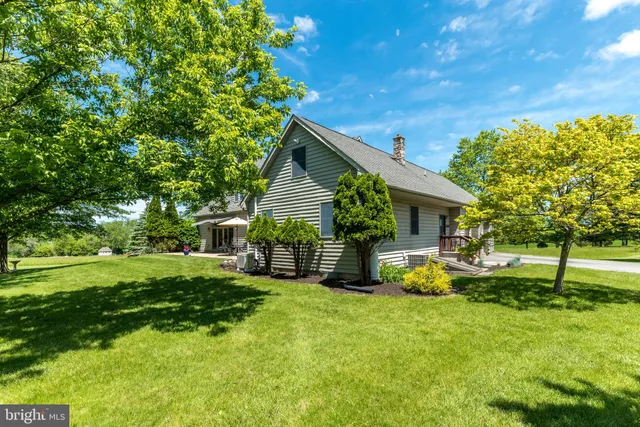 a kitchen with stainless steel appliances kitchen island granite countertop a stove a sink and a refrigerator