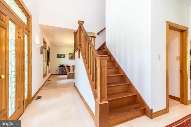 a large kitchen with kitchen island a large counter top space a sink stainless steel appliances and cabinets