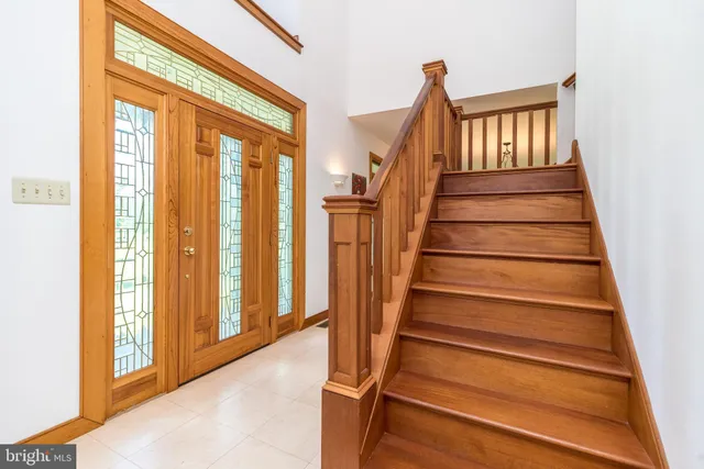 a living room with couches a dining table and chairs with wooden floor