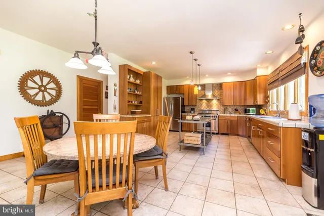 a bathroom with a granite countertop toilet a sink and a mirror