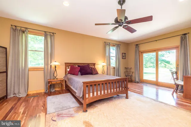 a spacious bedroom with two beds and a dresser