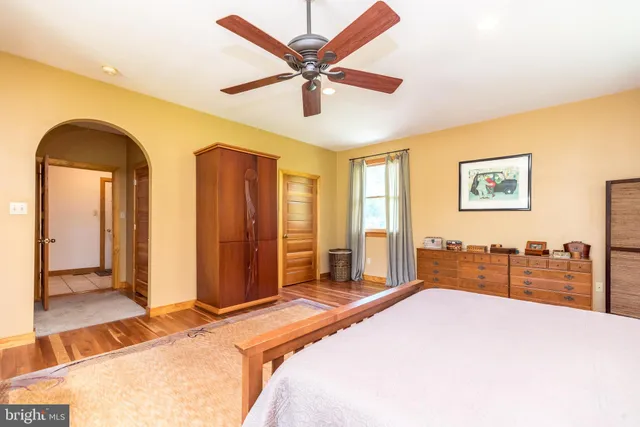 a bathroom with a granite countertop sink and a large mirror