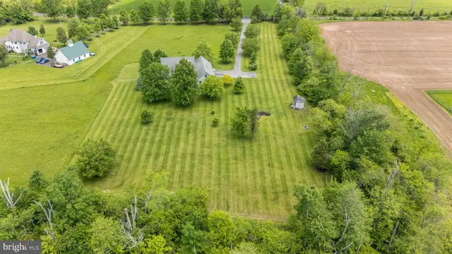 a view of a swimming pool with lawn chairs under an umbrella