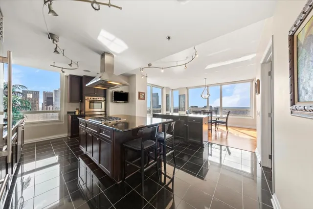 a kitchen with granite countertop a stove and a sink