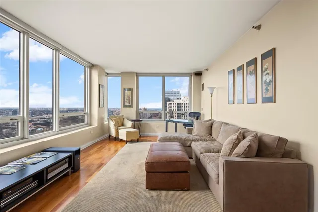 a bedroom with furniture a flat screen tv and a fireplace