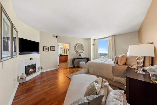a spacious bedroom with two beds and painting on the wall