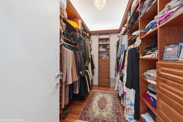 a large spacious bathroom with a tub a double vanity sink a mirror and a bathtub
