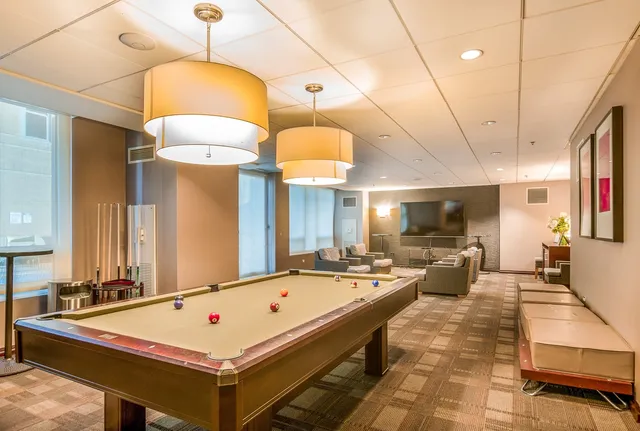 a view of a swimming pool with outdoor seating