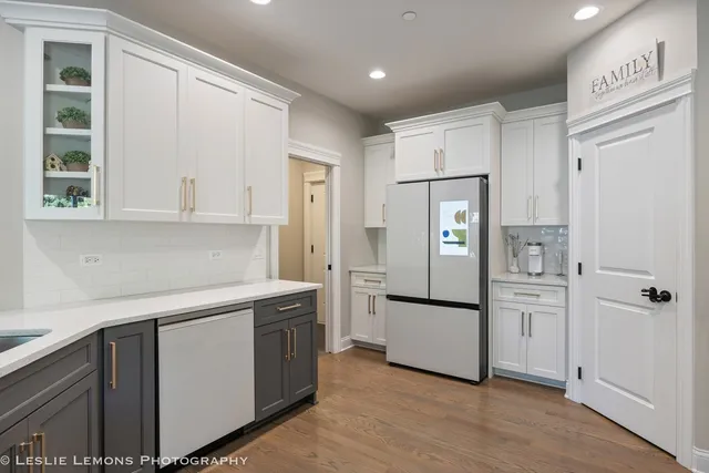 a kitchen with a refrigerator sink and cabinets