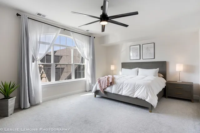 a bedroom with a large bed and a window