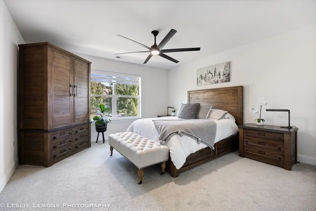 a bedroom with a bed dresser and a window