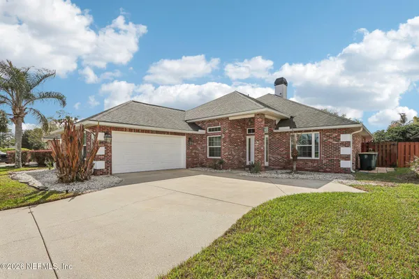 a front view of a house with a garden and pathway