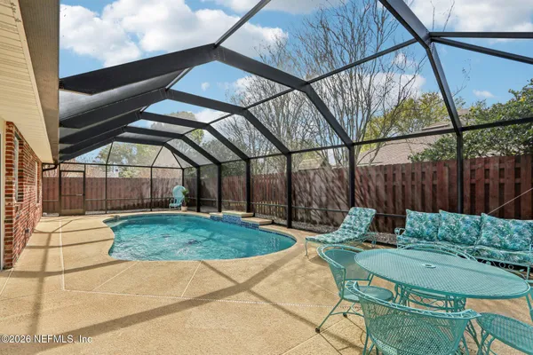 a living room with furniture a fireplace and a chandelier
