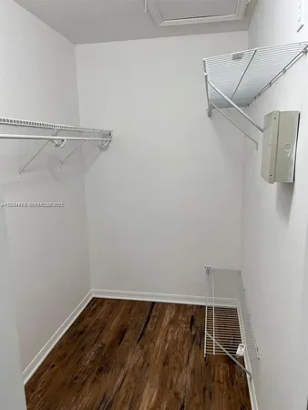a view of walk in closet with empty racks