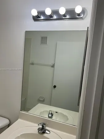 a bathroom with a sink and mirror