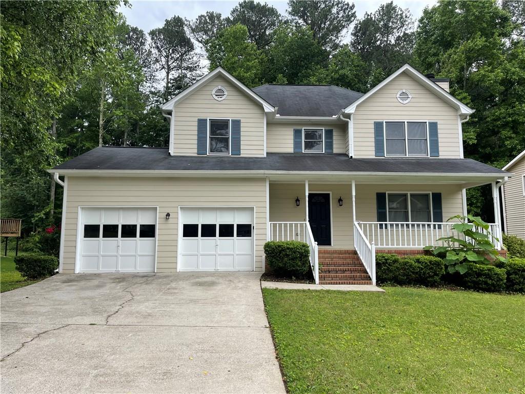 3310 Ridgerock Way Snellville, GA 30078 - Photo 1 of 1 a front view of a house with a yard and garage