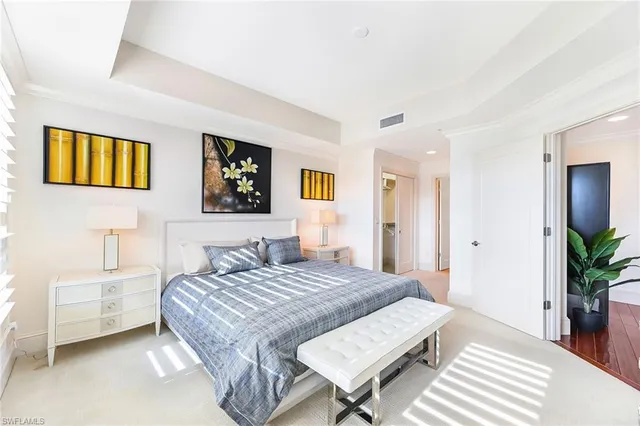 a bedroom with a bed and a table in it