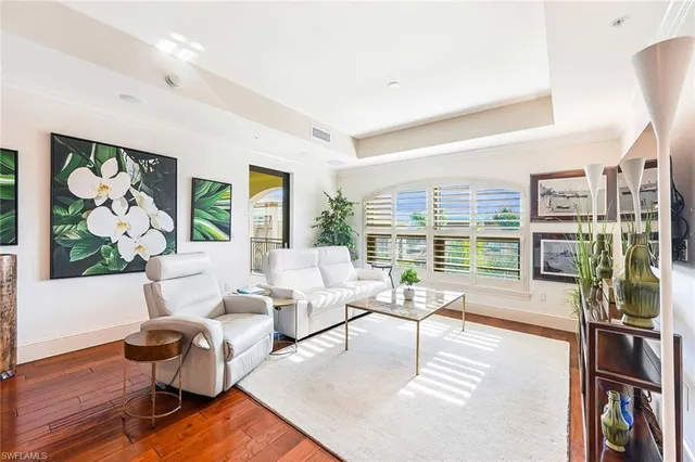 a living room with fireplace furniture and a large window