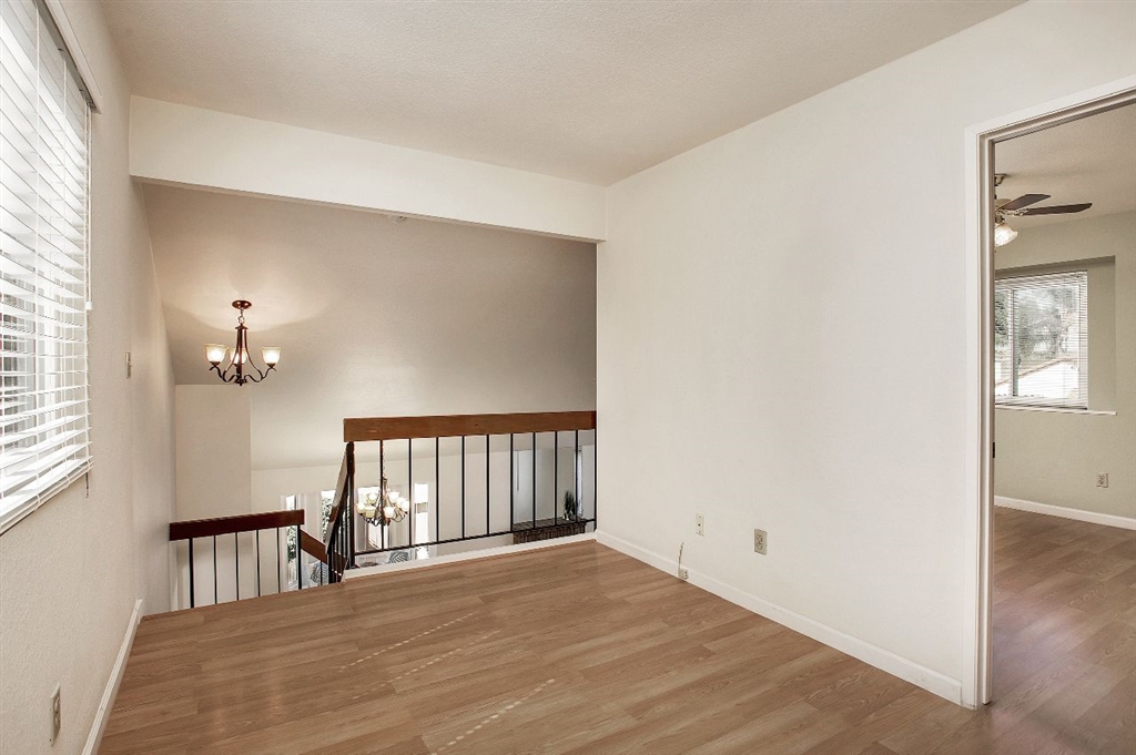 1980 Paseo Del Rey Vista, CA 92084 - Photo 15 of 25 a view of an empty room with window and wooden floor