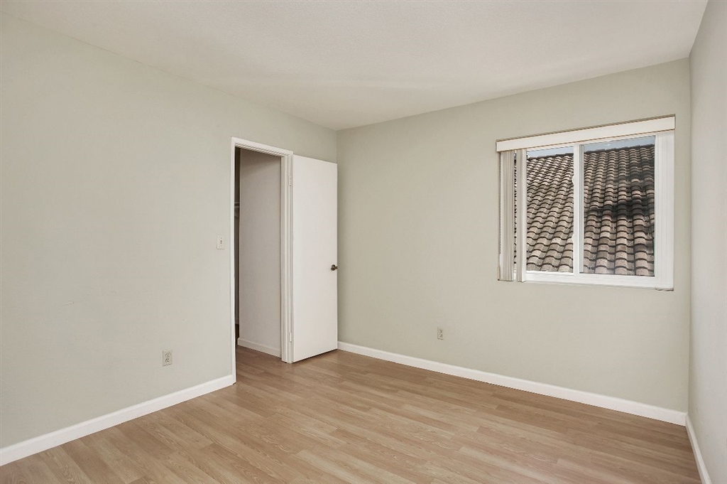 1980 Paseo Del Rey Vista, CA 92084 - Photo 16 of 25 an empty room with wooden floor and windows