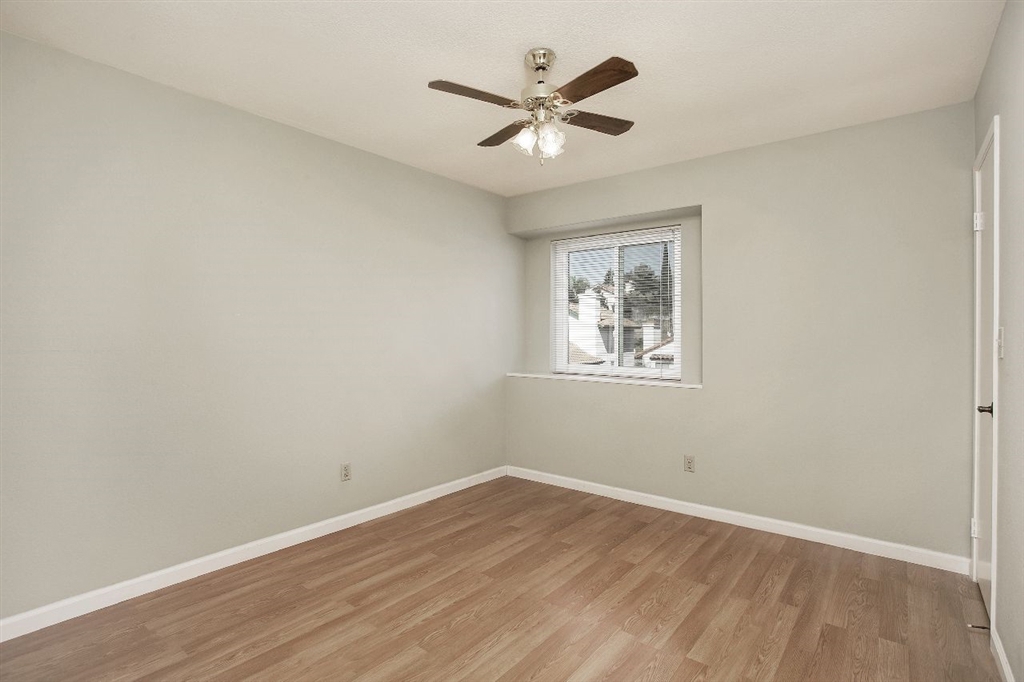 1980 Paseo Del Rey Vista, CA 92084 - Photo 18 of 25 an empty room with wooden floor and ceiling fan