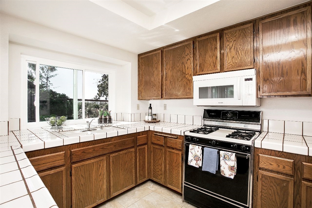 1980 Paseo Del Rey Vista, CA 92084 - Photo 8 of 25 a kitchen with a sink stove top oven and cabinets