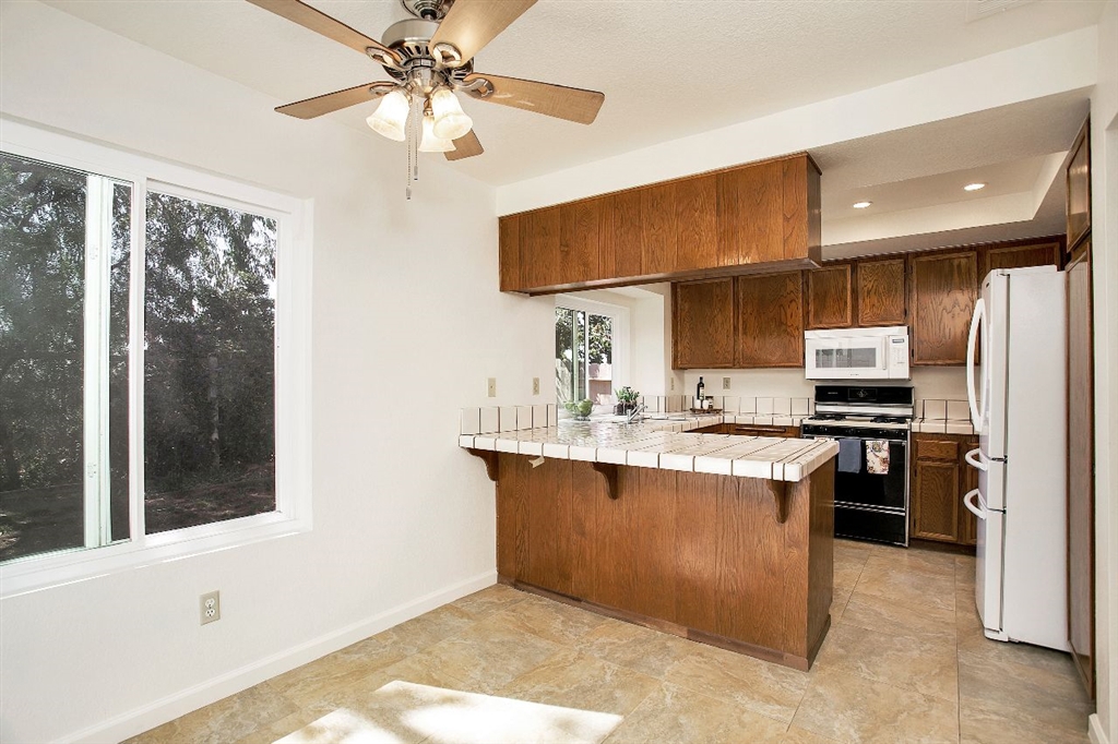 1980 Paseo Del Rey Vista, CA 92084 - Photo 10 of 25 a kitchen with stainless steel appliances granite countertop a sink and a stove