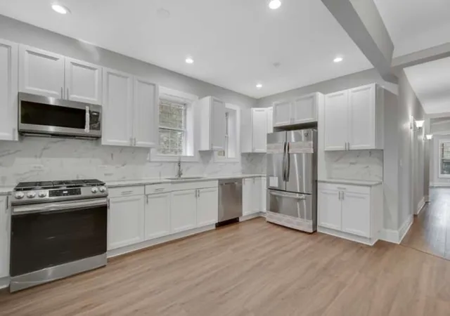 a kitchen with a stove a sink and a microwave