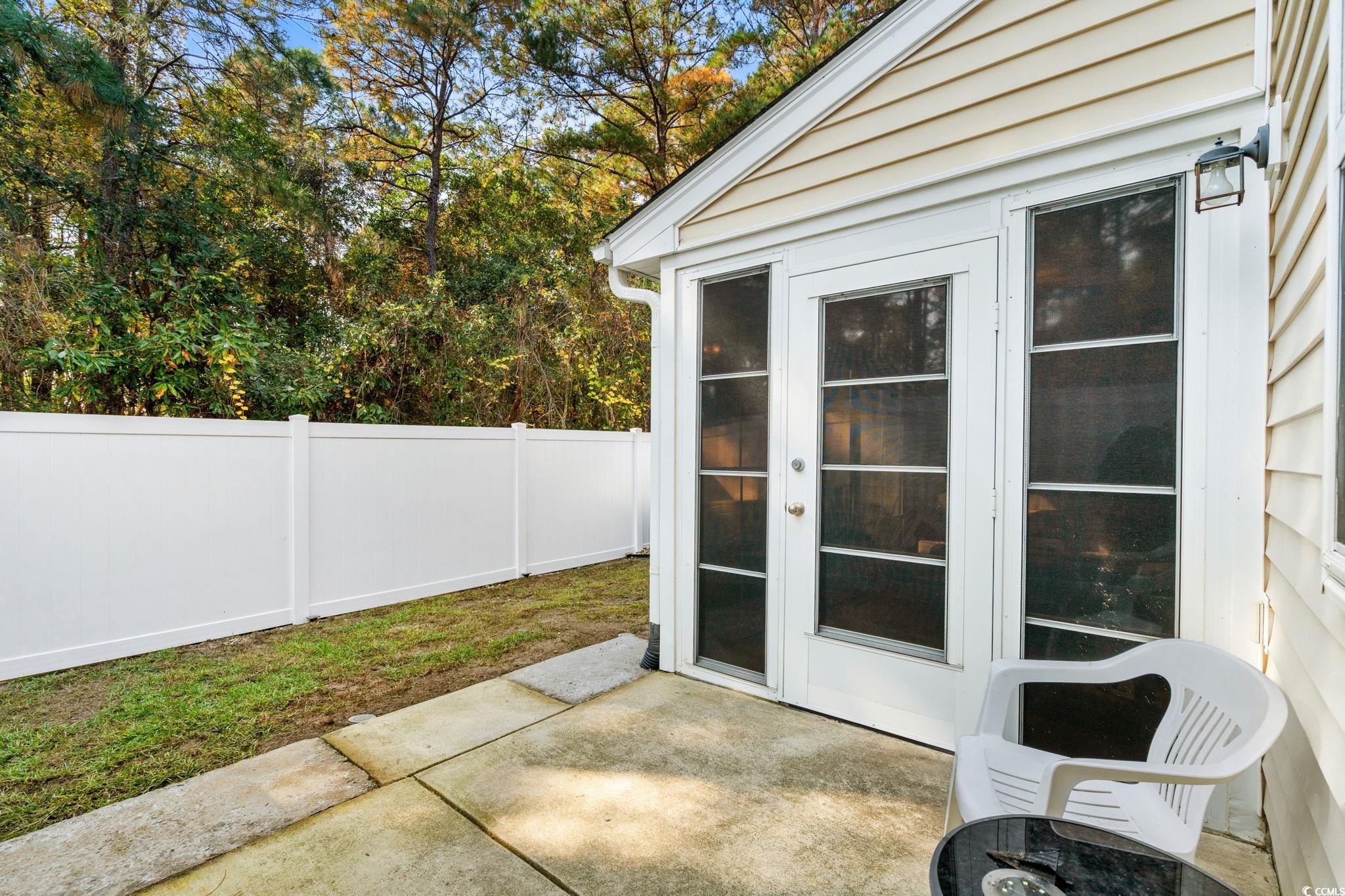399 Seabert Road, Unit 209 Myrtle Beach, SC 29579 - Photo 23 of 40 View of patio with view of wooded area