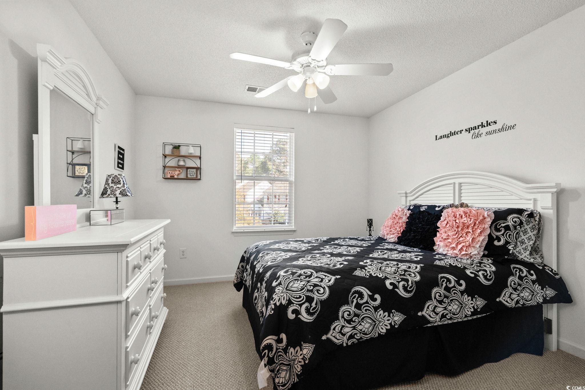 399 Seabert Road, Unit 209 Myrtle Beach, SC 29579 - Photo 31 of 40 Bedroom featuring light carpet, a ceiling fan, and a textured ceiling