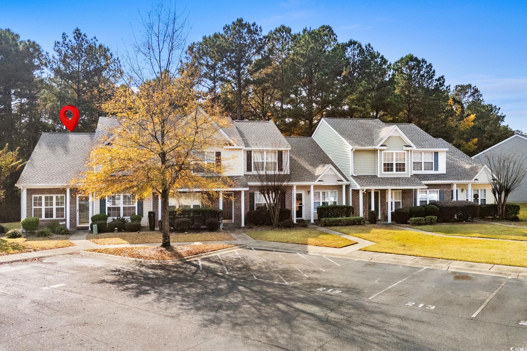 399 Seabert Road, Unit 209 Myrtle Beach, SC 29579 - Photo 34 of 40 Traditional-style house featuring a porch, uncovered parking, and a front yard