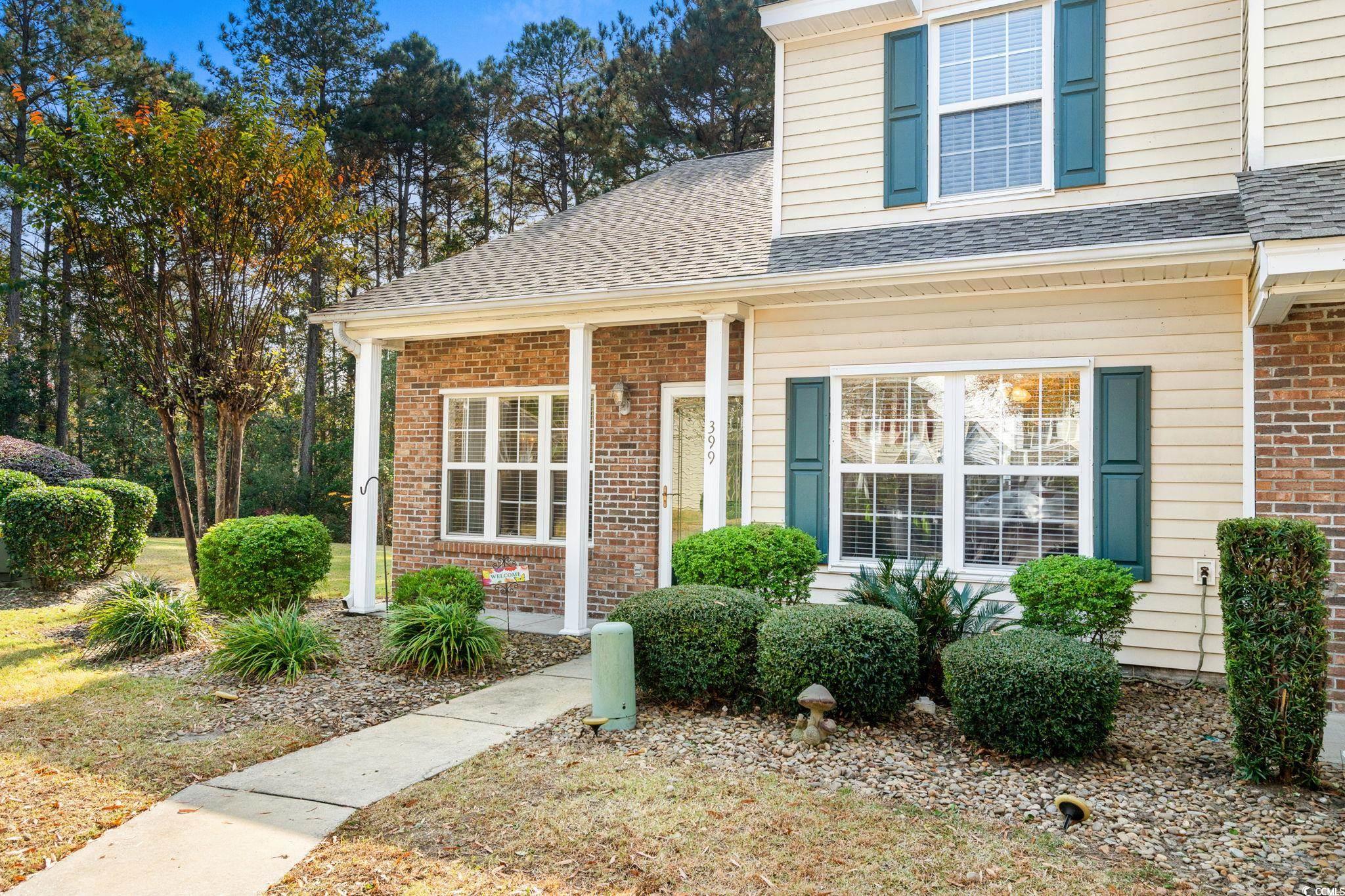 399 Seabert Road, Unit 209 Myrtle Beach, SC 29579 - Photo 4 of 40 Entrance to property with brick siding, a porch, and a shingled roof