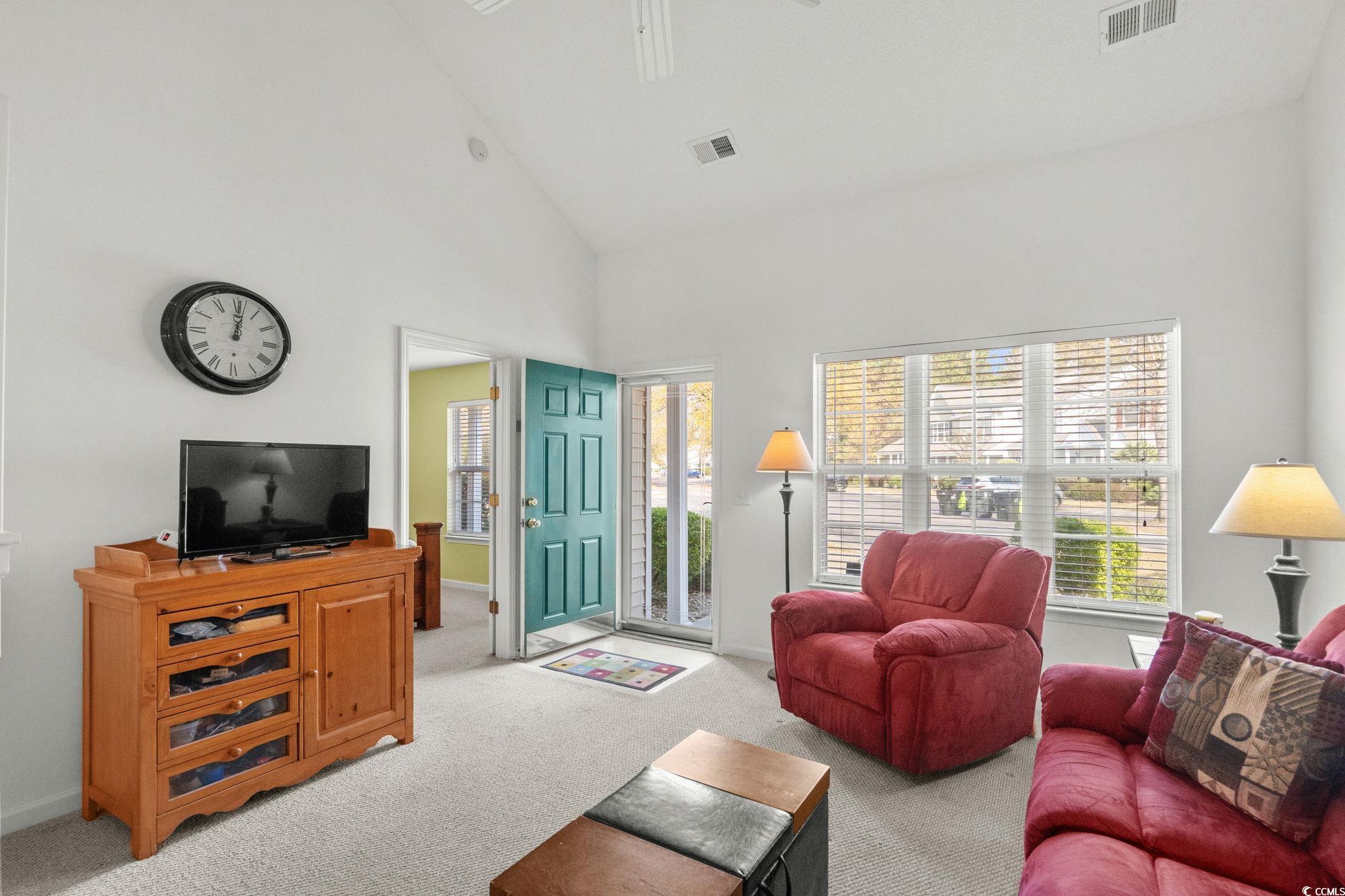 399 Seabert Road, Unit 209 Myrtle Beach, SC 29579 - Photo 6 of 40 Carpeted living room with high vaulted ceiling and ceiling fan