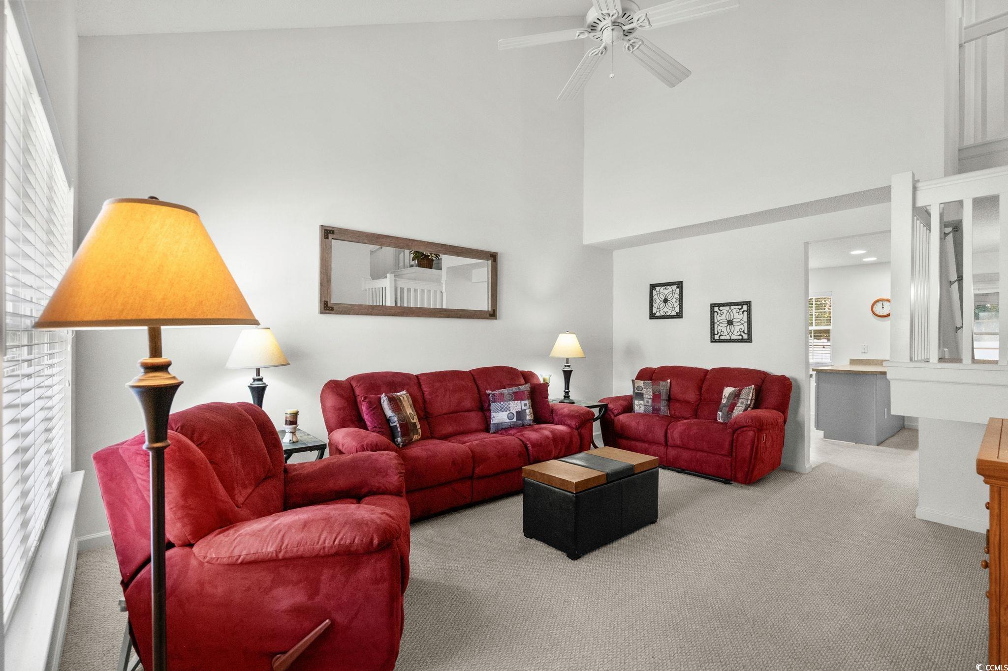 399 Seabert Road, Unit 209 Myrtle Beach, SC 29579 - Photo 7 of 40 Living room with carpet, a ceiling fan, and a towering ceiling