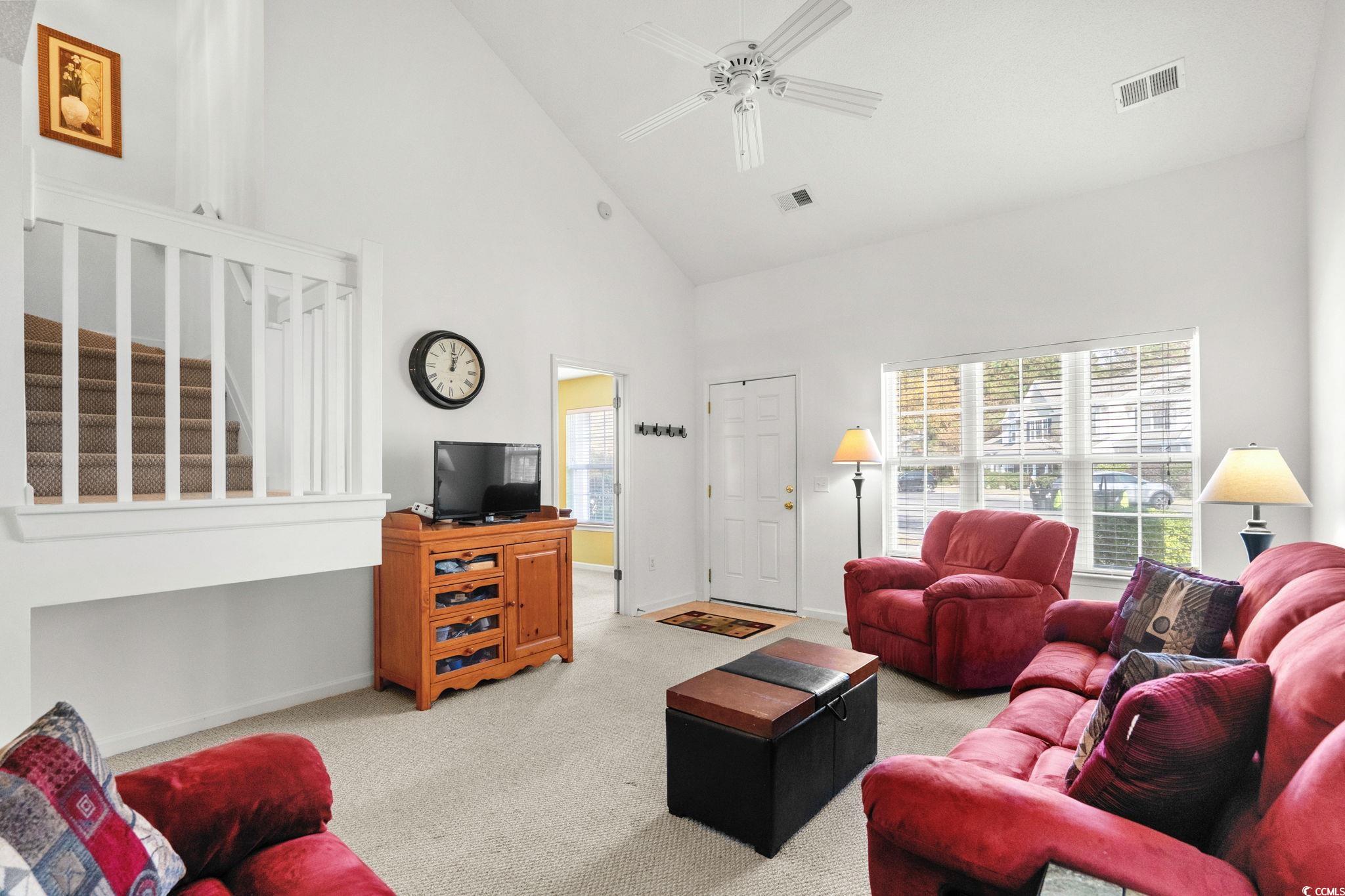 399 Seabert Road, Unit 209 Myrtle Beach, SC 29579 - Photo 9 of 40 Carpeted living room with high vaulted ceiling, ceiling fan, and stairway