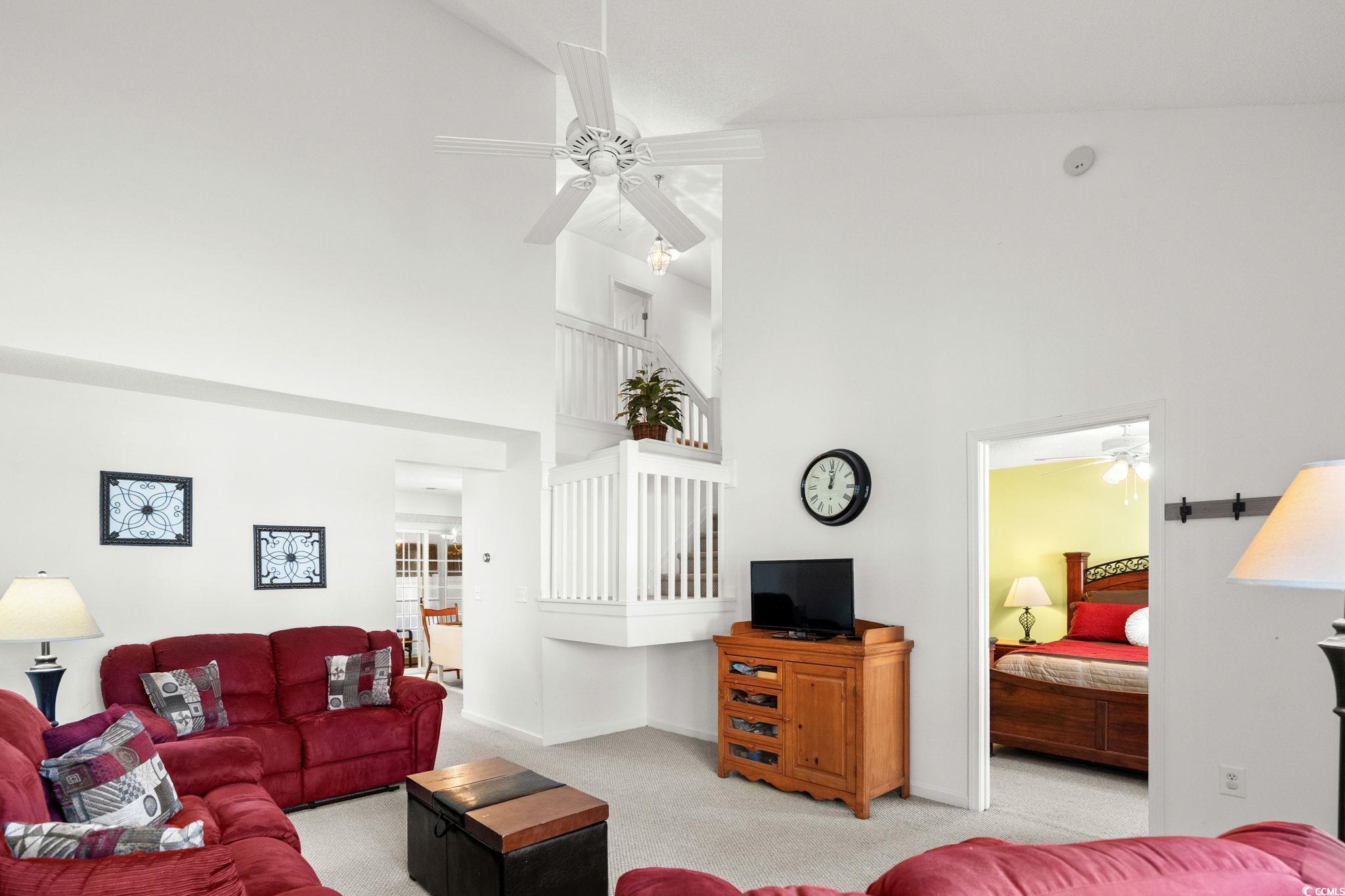 399 Seabert Road, Unit 209 Myrtle Beach, SC 29579 - Photo 10 of 40 Carpeted living room featuring ceiling fan and high vaulted ceiling