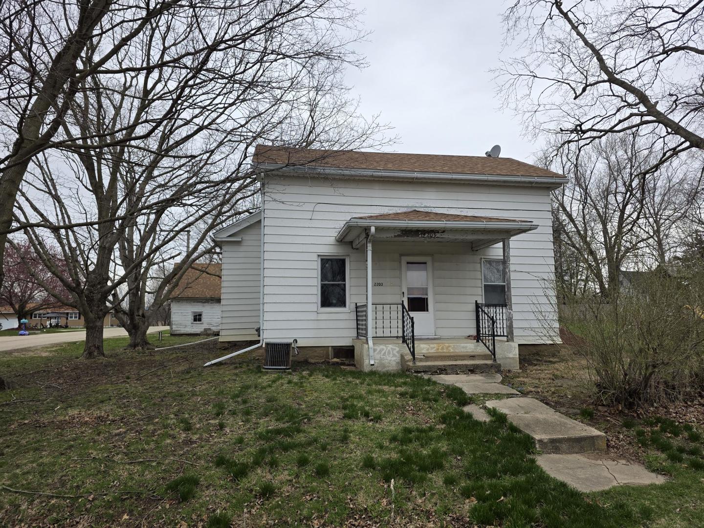 2203 Deets Road Sterling, IL 61081 - Photo 1 of 13 a front view of a house with garden