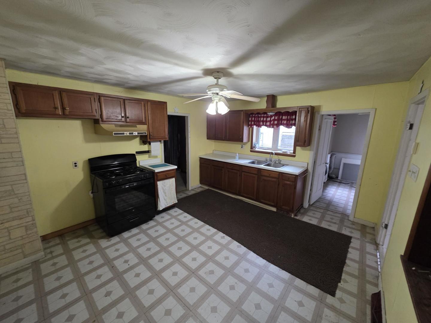 2203 Deets Road Sterling, IL 61081 - Photo 7 of 13 a kitchen with a sink appliances and cabinets