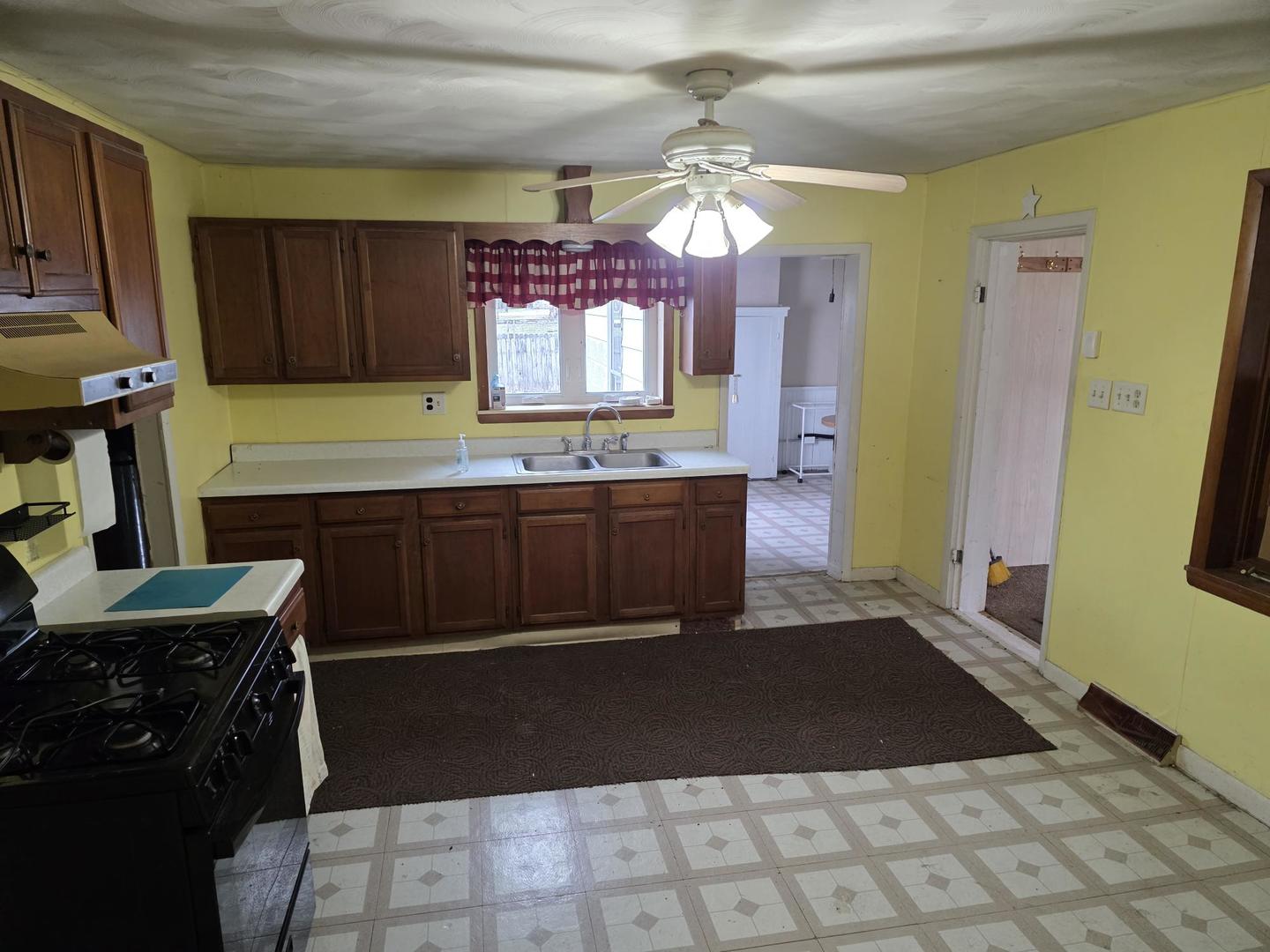 2203 Deets Road Sterling, IL 61081 - Photo 8 of 13 a kitchen with stainless steel appliances a sink stove and cabinets
