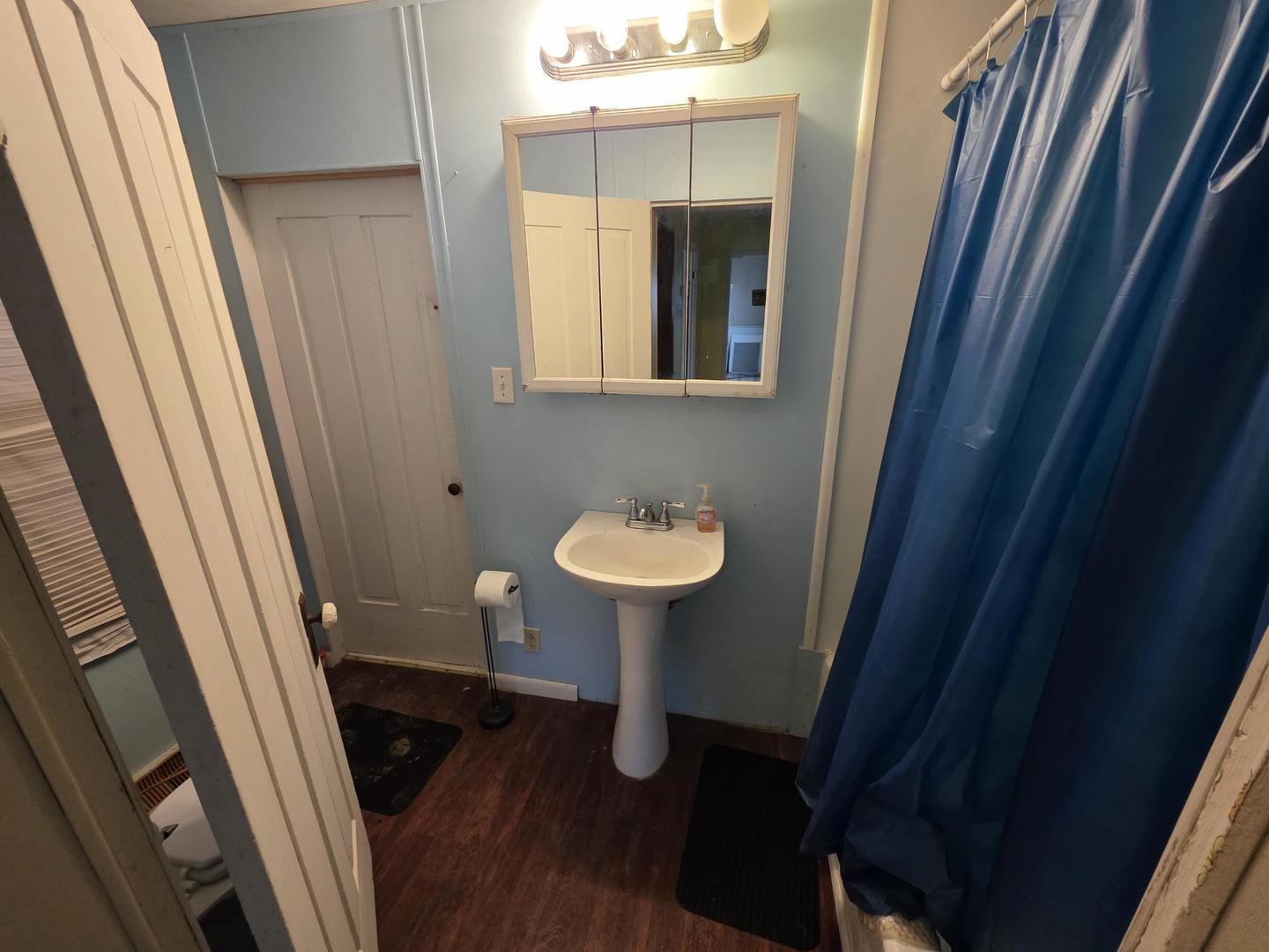 2203 Deets Road Sterling, IL 61081 - Photo 10 of 13 a bathroom with a sink a mirror a toilet and a window